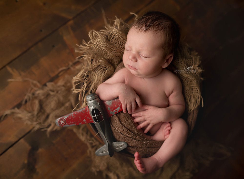newbornposeairplane Nashville Infant Photographer
