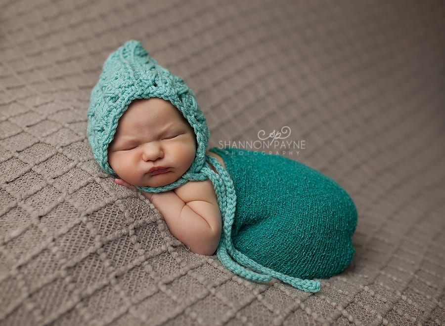 newborn girl in gray and teal