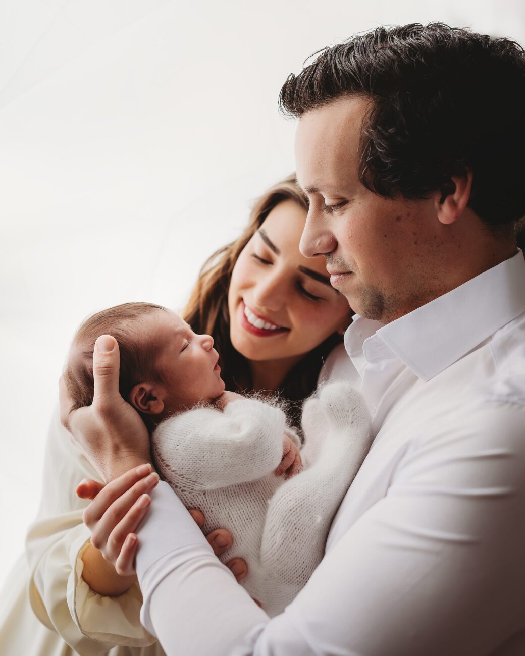 new parents hold newborn baby during nashville newborn studio portrait session